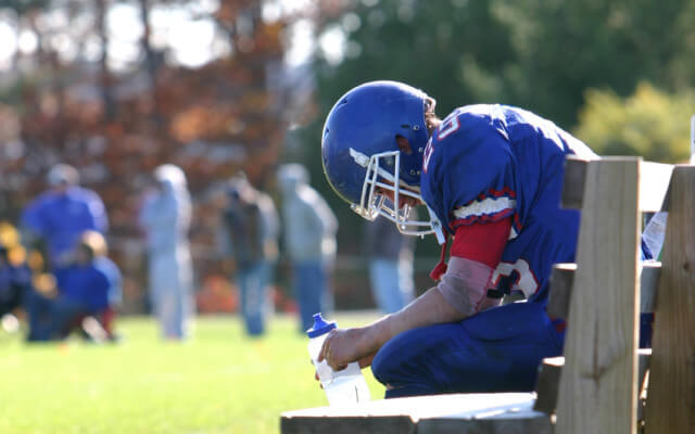 Dark side of college sports concept with high contrast lighting on