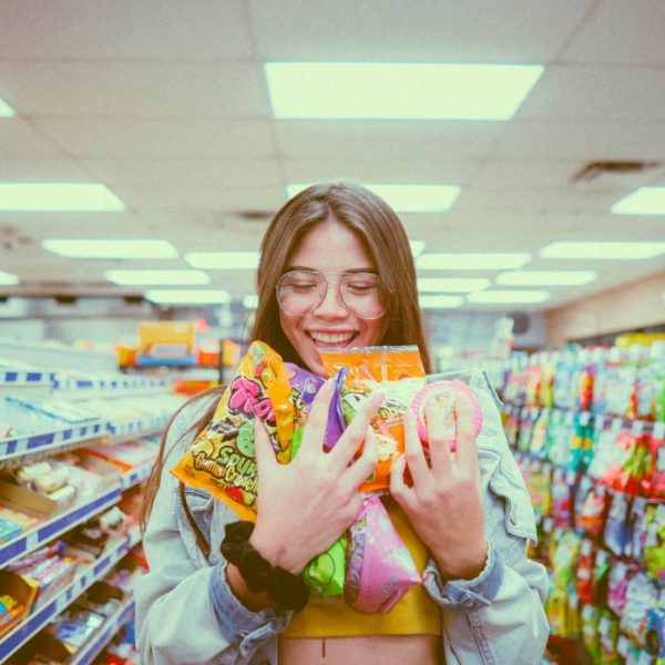 girl holding bags of candy smiling