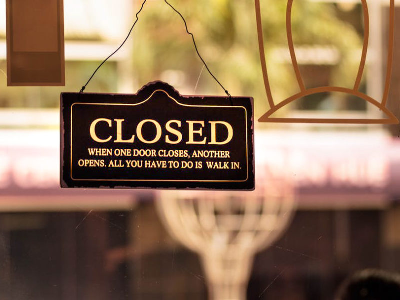 Closed sign hangs in a campus coffee shop's window.