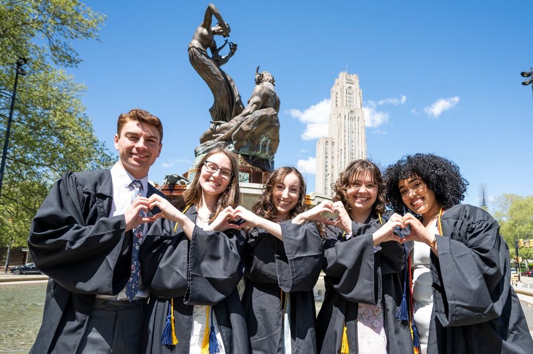 2024 University of Pittsburgh grads celebrate together at Mary Schenley Memorial Fountain.